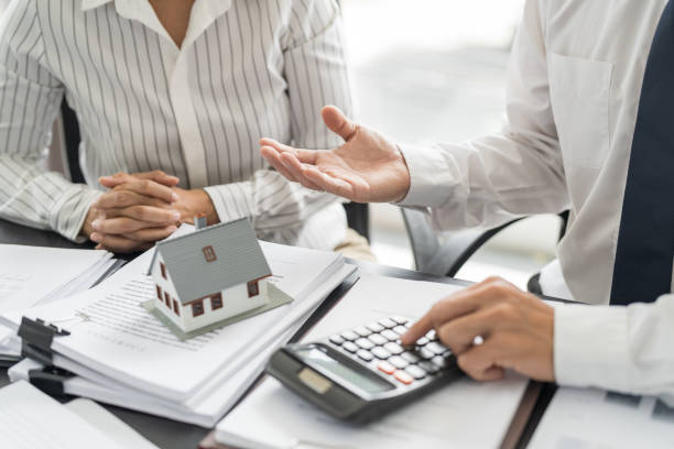 istock Sales manager giving advice application form document, considering mortgage loan offer for car and house insurance. Real estate investment Property insurance and security. Real estate agent offer house 1779436929