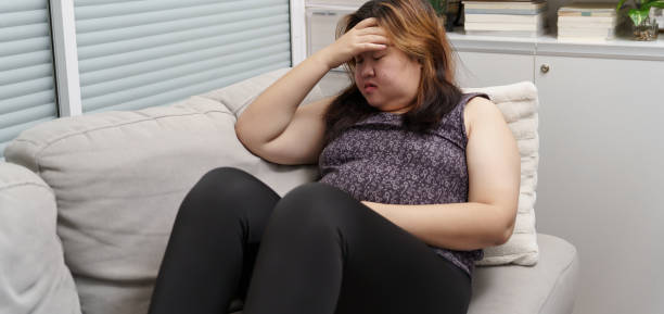 istock Sad Overweight plus size woman thinking about problems on sofa upset girl feeling lonely and sad from bad relationship or Depressed woman disorder mental health 1779442352