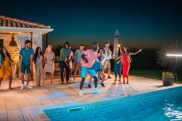istock Joyful Friends Celebrating by the Pool at Night 1779449640