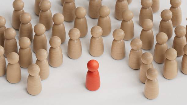 istock Discrimination and inclusion concept. The wooden figurines surrounded the red one.3D rendering on white background.Discrimination and inclusion concept. The wooden figurines surrounded the red one.3D rendering on white background. 1779477229