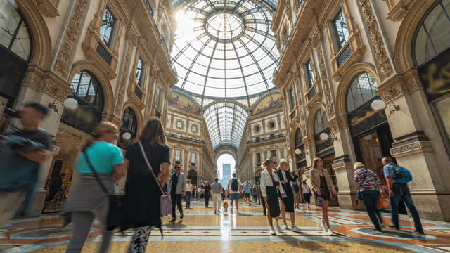 Time lapse of Crowded people tourist walking and shopping fashion brand name product in Galleria Vittorio Emanuele II at Piazza del Duomo in Milan, Italy