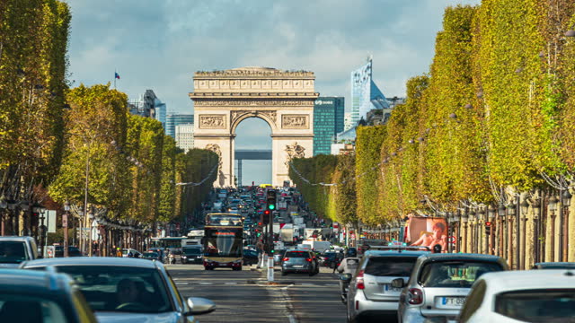 Time lapse of Crowded street Traffic on Champs-Elysees road of Arc de Triomphe de l'Étoile is one of the most famous monuments in Paris, France
