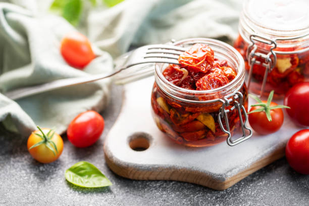 istock Jars with sun dried tomatoes with fresh herbs and spices. 1779555622