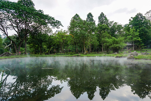 Mineral hot water in hot springs and morning fog background. the park is also host to caves and hot springs. Chae Son Hot Spring National Park, famous spot location in Lampang, Northern of Thailand