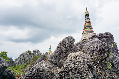 Pagoda on top of the cliff high mountain at Chaloem Phrakiat Phrachomklao Rachanuson temple (Wat Phrabat Pu Pha Daeng) in Thailand. Temple on the mountain and blue sky.