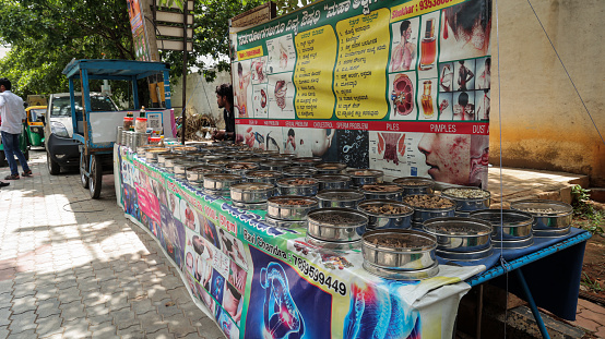 Bangalore,India-July 3,2023:A wide view of Ayurvedic herbs and roots is displayed at a roadside herbal stall. medicinal natural ingredients on display at city road