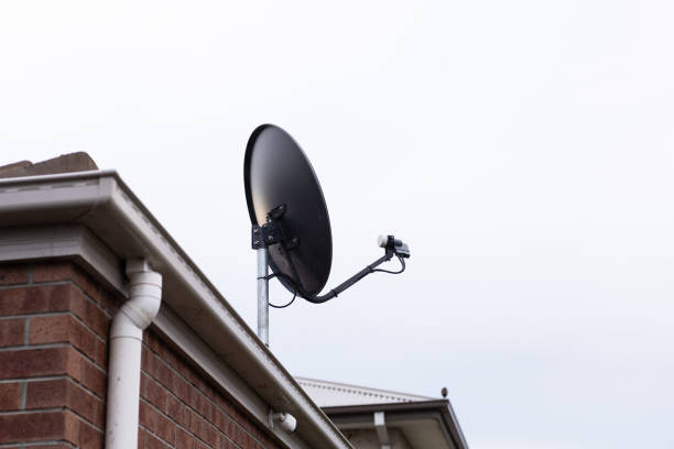 istock Satellite TV dish antenna on house roof 1779596837