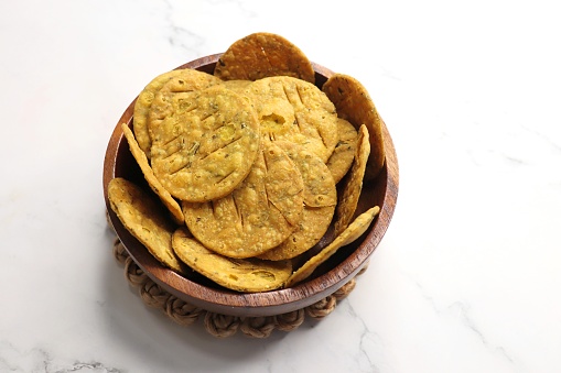 Crispy and crunchy methi mathri is a popular tea time snack in north India. It's especially popular during the Diwali festive season. It's a savory cracker or Masala puri. Copy Space.