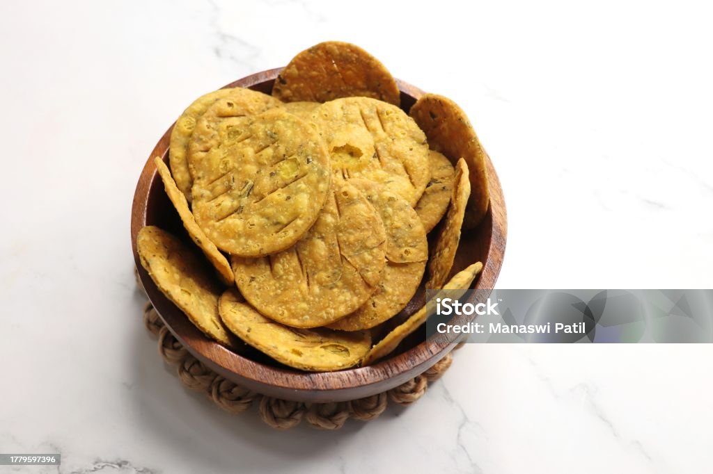 Crispy and crunchy methi mathri is a popular tea time snack in north India. It's especially popular during the Diwali festive season. It's a savory cracker or Masala puri. Copy Space. Masala Stock Photo