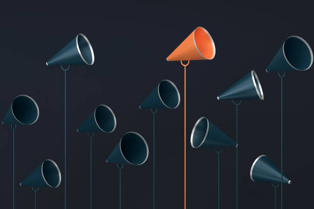 four loudspeakers on top of a pole