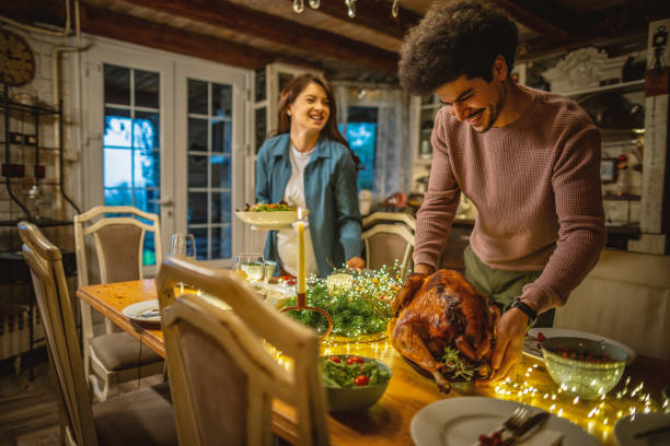 istock Young couple serving a Christmas table 1779605638