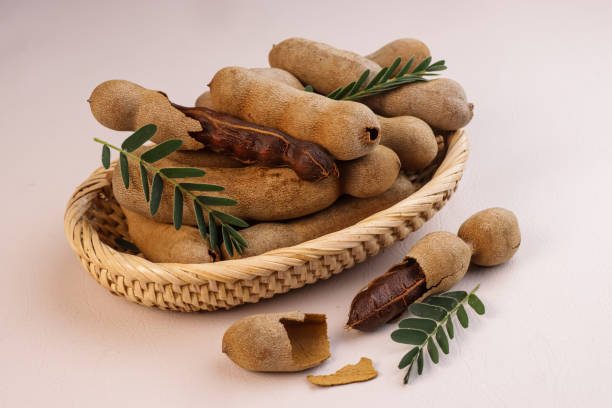 istock Buah Asam or Tamarind (Tamarindus) Fruit With Green Leaves. 1779627263