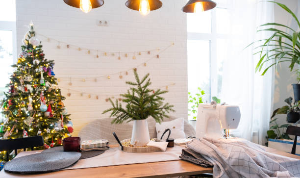 istock Sewing process on a sewing machine, a needle with a thread and a holder close-up stitch the white checkered fabric. Preparation for Christmas and new year, textiles for cozy in festive decor interior 1779637375