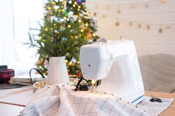 istock Sewing process on a sewing machine, a needle with a thread and a holder close-up stitch the white checkered fabric. Preparation for Christmas and new year, textiles for cozy in festive decor interior 1779637380