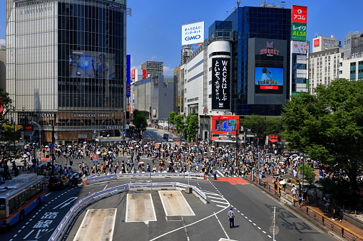 Tokyo, Japan- April 2nd, 2023: Shibuya Scramble Crossing with many people crossing the junction in Tokyo Japan