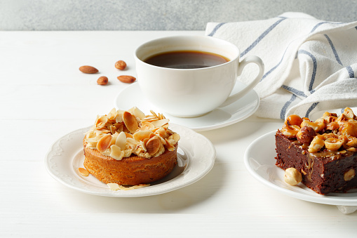 Almond tart and brownie on white background close up