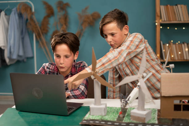 istock Homeschooling. Smart children work as a team using laptop computer to program wind turbines. Students learning about eco-friendly forms of renewable energy at home. 1779660690