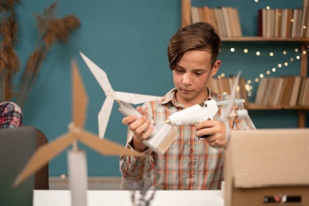 istock Smart young child work making wind turbines project at home. Boy learning about eco-friendly forms of renewable 1779660701