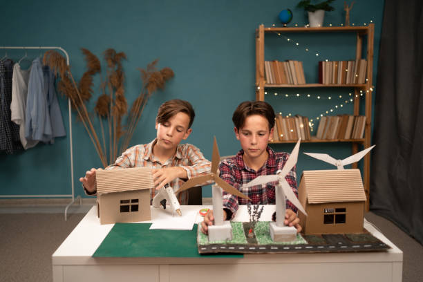 istock Two boys students create a wind energy project and a house of the future studying at home 1779661206