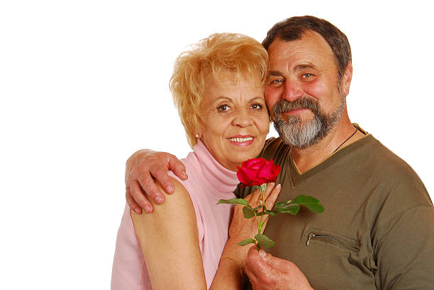 istock Happy older couple with the red rose in their hands 177966295