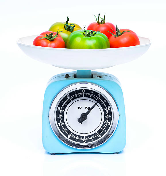 Weight scale with fresh tomatoes stock photo