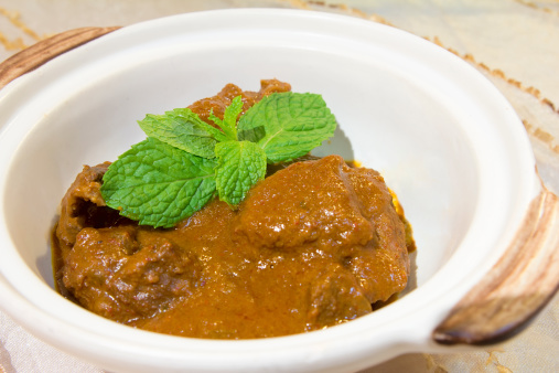 Nonya Peranakan Curry Beef Rendang with Mint Leaves Garnish Closeup
