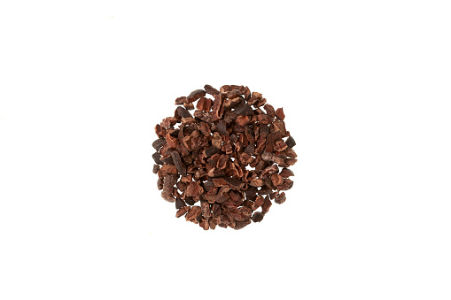 Handful Cocoa nibs on white background, top view. Design element. Cacao Nibs are packed with mood- and energy-boosting nutrients. Pure superfood, Gluten-Free.