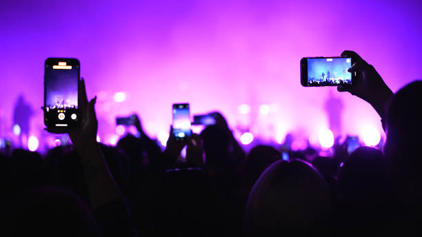 Music fan record concert mobile phone. People crowd shoot video party Neon light A lot of fun happy people record music video use mobile phone. Fan crowd shoot k pop live concert. Many men enjoy hang out cool rave fest. Joy group chill at night club party. Make neon light photo. mobile phone lights up stock pictures, royalty-free photos & images