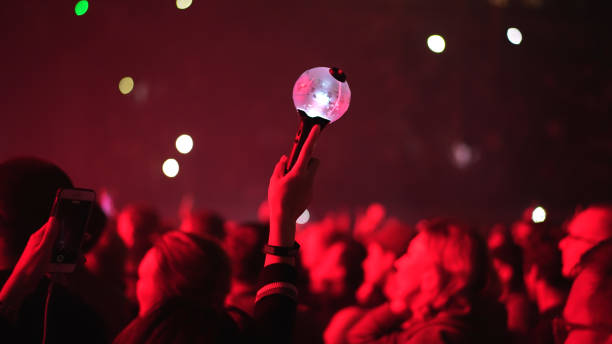 K pop fan raise bomb light stick lamp. Korean kpop music concert. Asian bts band Bts k pop band fan raise hand up hold bomb light stick lamp. Fun korean people enjoy kpop live music concert. Crowd hang out cool night show. Asian idols army wave red flash light. Joy party fest tour k pop stock pictures, royalty-free photos & images