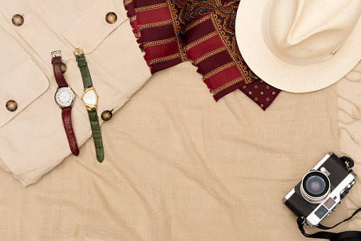 Panama hat, scarf and jacket on textile background