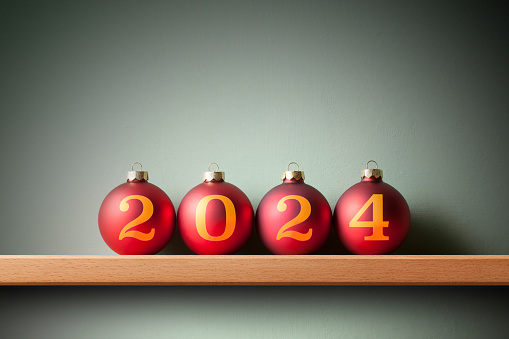 Christmas and Happy New Year 2024. Christmas balls on the shelf.