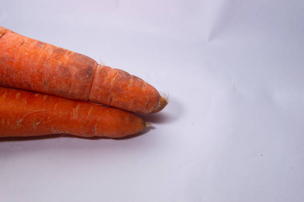 Bunch of Carrots Tied with Rubber Band on Butcher Block