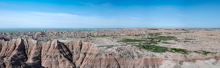 Panorama of the Badlands from Pinnacles Overlook show eroded buttes with grassland (prairie) valleys. Badlands National Park, South Dakota, USA.