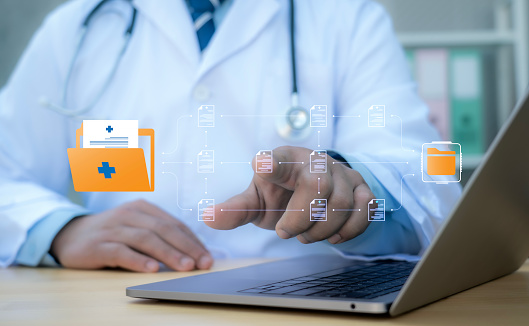 A medical worker works with an electronic database and documents.Technology and access information, database, storage, Digital link tech, big data