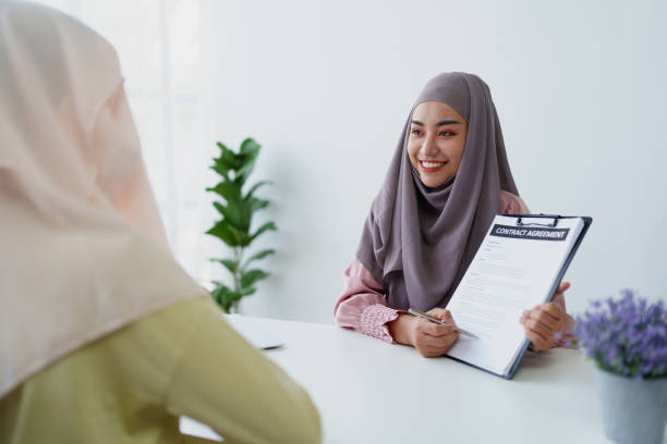 istock Muslim female employee Hold important documents and discuss agreements with customers. 1779727946