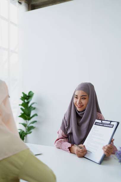 istock Muslim female employee Hold important documents and discuss agreements with customers. 1779730062