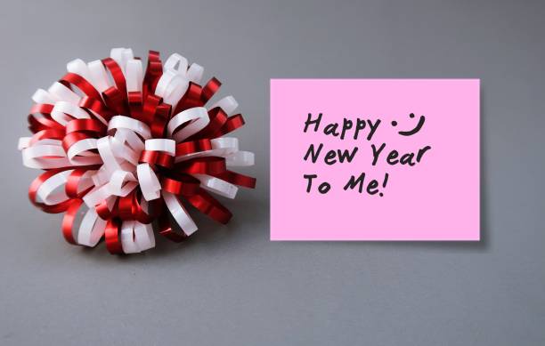 istock A red white gift bow and a pinlk sticky note on gray background with text written Happy New Year To Me, concept of modern day lifestyle or single people who spend their New Year Holiday season alone by themselves 1779733035
