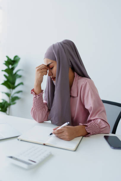 istock Muslim female employee working in office burnout. 1779733095