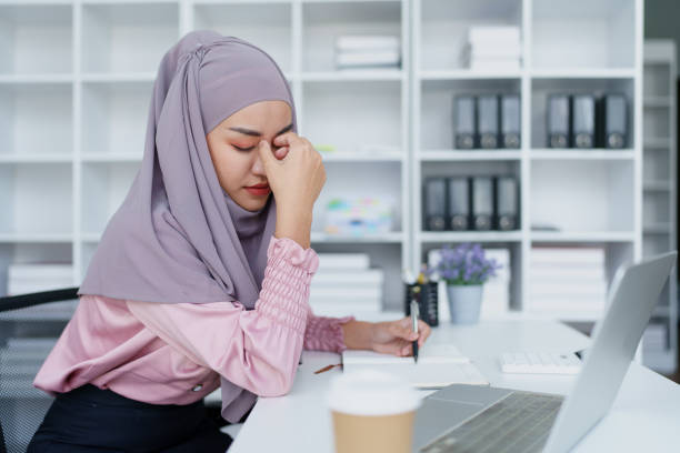istock Muslim female employee working in office burnout. 1779734691
