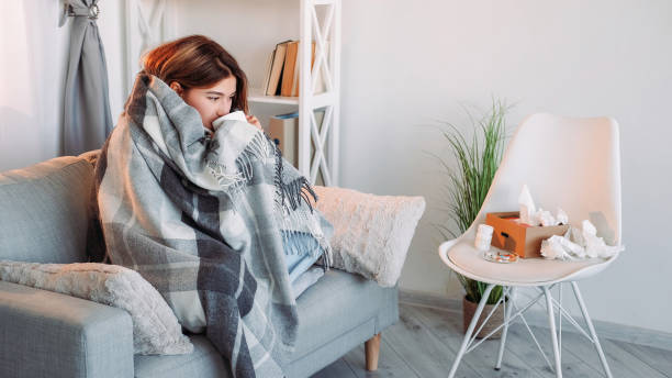 istock Flu drinking sofa influenza sick unhealthy woman 1779735625