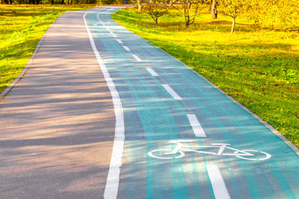 empty bicycle path with markings in a city park. bicycle sign on the bike path
