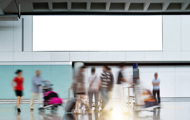 istock Blank billboard at the airport, with passengers rush walking 1779738965