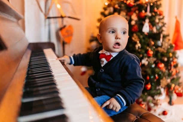 istock Baby Boy Playing The Piano For Christmas 1779740180