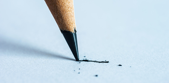 A pencil for writing or drawing blue colour with an eraser isolated on a white background. Close up, with copy space for your text.