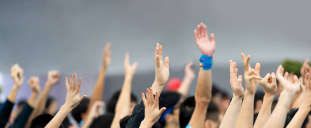 istock Many hands raised in a crowd of people 1779741243