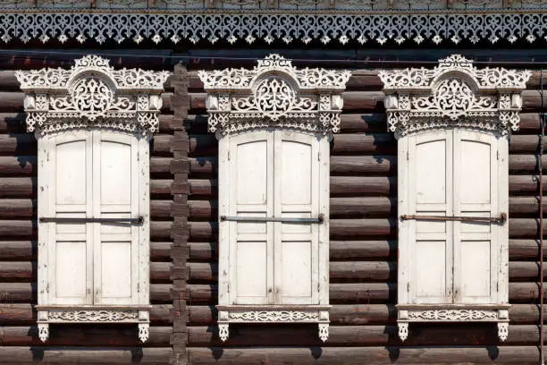 Details of the window-frames and shutters of a traditional Siberian wooden house near Holy Cathedral Odigitrievsky in Ulan-Ude, Russia.