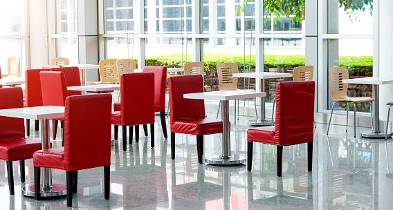 Office bar with many red chairs and table