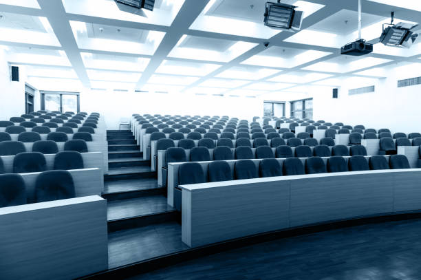 istock Empty college lecture hall with row of chairs 1779743461