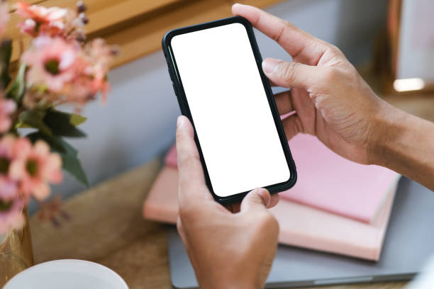 istock Rear view of young man sitting at his workspace and using smartphone. Blank screen 1779763800