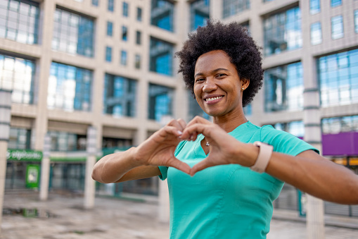 Portrait of beautiful nurse showing heart shape with hands